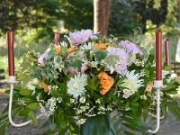 κατασκευή λουλουδιών σε μεταλλικό κηροπήγιο με ροζ παιόνιες, πορτοκαλί τριαντάφυλλα, χαμομήλι, λευκή ντάλια και δίχρωμο κισσό